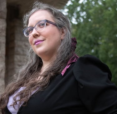 Portrait of a woman in a business suit with a violet hairbow