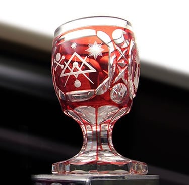 A crystal goblet with cut to clear Mason symbols