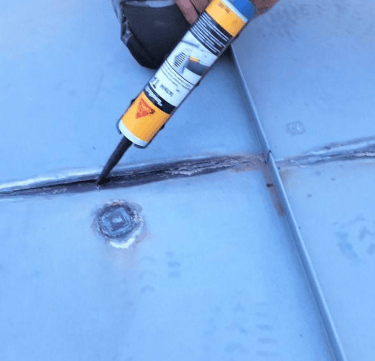 Licensed roofer performing emergency roof repair after tree damage in Ivy Charlottesville