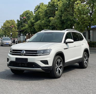the front of a black car in a garage