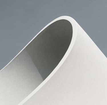 Editorial photography, close-up of a white architectural curve against a soft gray sky, high-contrast, minimalist composition, sharp focus and clean lines. Global / Contemporary Art.