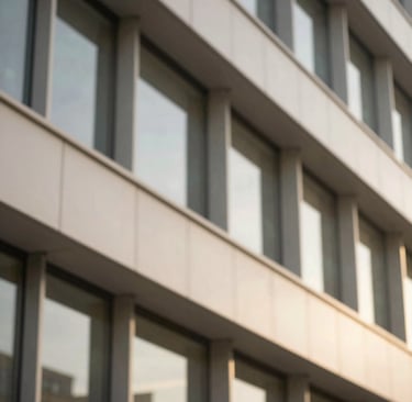 Close-up of modern architectural details in a clean, sophisticated office building, warm natural light, muted corporate tones, shallow depth of field.