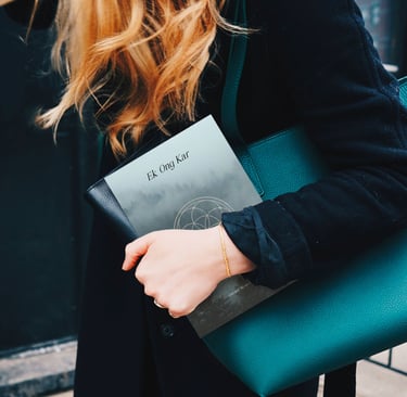 a woman in a black coat and a green purse