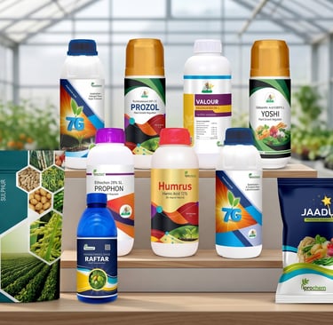 A collection of agricultural fertilizers and pesticides on a wooden table inside a bright greenhouse.