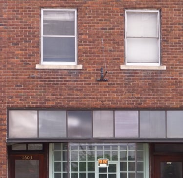 A for rent sign hangs in an empty business in a small town in Nebraska