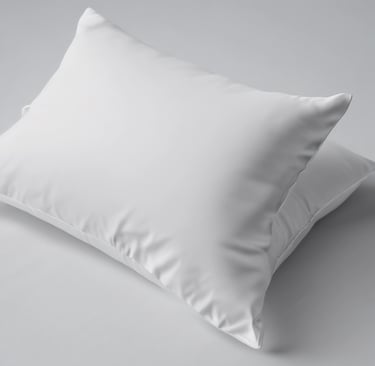 Close-up of a smooth qatan pillow protector with fine stitching and a subtle texture on a cozy bed.