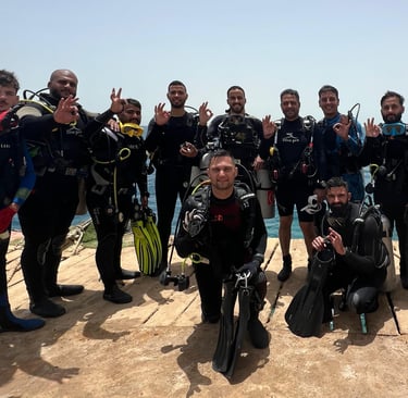 a group of scuba divers in full body suits
