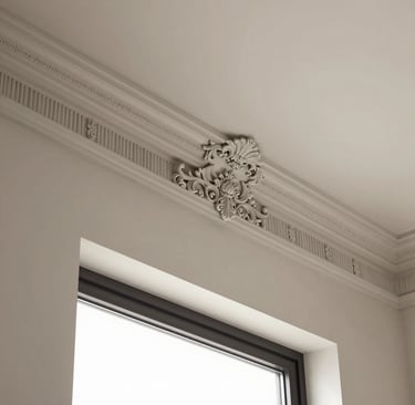 A bright kitchen featuring freshly installed crown molding above cabinets.