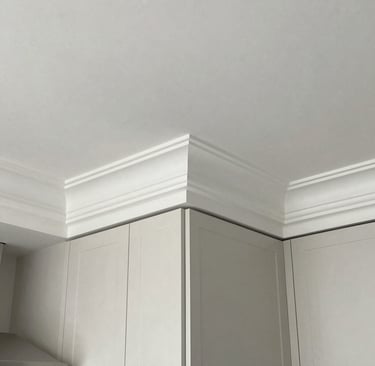 Detailed view of intricate crown molding paired with soft ambient lighting.