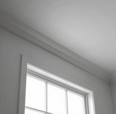Close-up of elegant white crown molding framing a cozy living room ceiling.