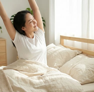 Woman stretching peacefully in bed after restful sleep in bright minimalist bedroom