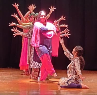 Ms. Chaitali Biswas guiding students through intricate kathak footwork during a lively class session