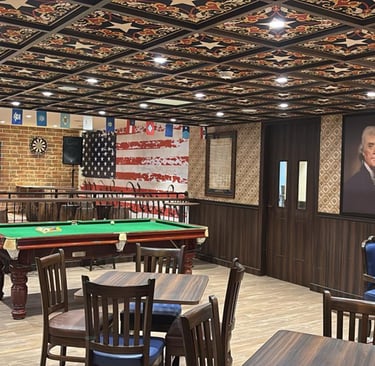 American themed game room with a pool table, dartboard, and patriotic decor.
