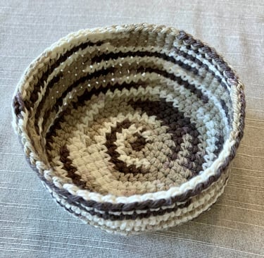 Brown, tan, cream colored crocheted coaster basket.