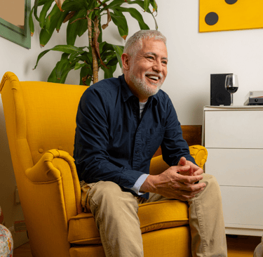 Hispanic man smiling in  chair
