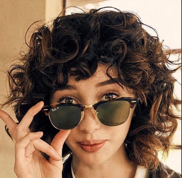 Woman looking over her Ray-Ban sunglasses