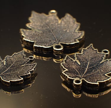 three 3 dimensionally engraved maple leaves with eyelets for ewelry, home made on whyte avenue