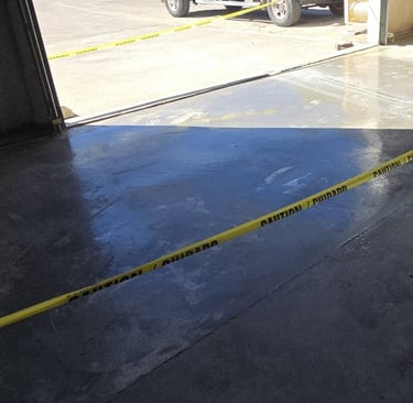 a garage floor with a yellow tape tape tape and a yellow tape tape