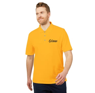 A man wearing a vibrant yellow polo shirt with a black Glow logo on the chest.