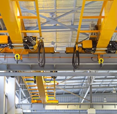 2 bridge cranes with rope hoists lined up for inpsection