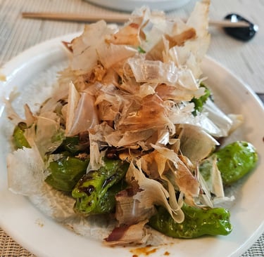 Blistered shishito peppers finished with dancing bonito flakes at Zōtō Sushi in Sarasota, Florida