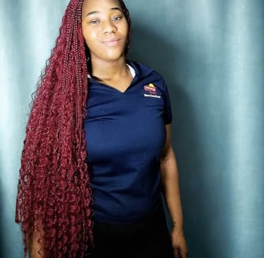 a woman with long red boho braids hairstyle