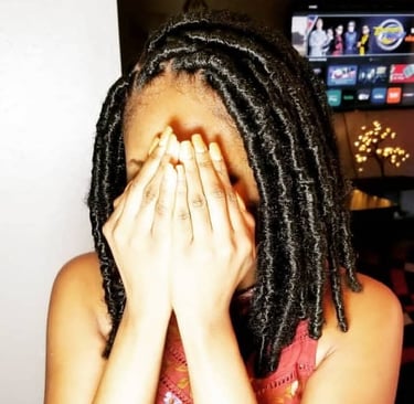 a woman with a large black butterfly locs