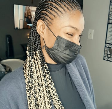 a woman with cornrows hairstyle