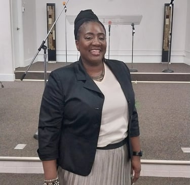 A woman standing in church smiling