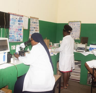 Laboratory technicians in white coats using microscopes and medical equipment in a clinical lab setting.