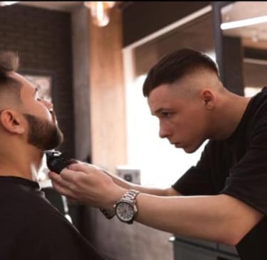 Professional barber providing a modern haircut service at Alpha Studio in Vilnius