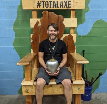 man sitting on a throne holding a trophy