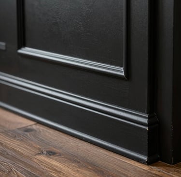 A bright, open-concept living room showcasing fresh paint, minimalist decor, and large windows.