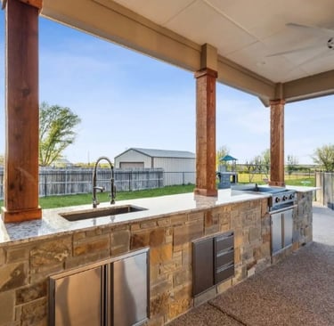 a kitchen with a large outdoor kitchen and a grill