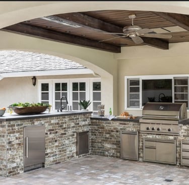 a kitchen with a grill and a television