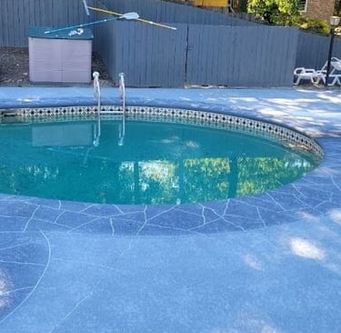 a pool with a pool and a fenced in area