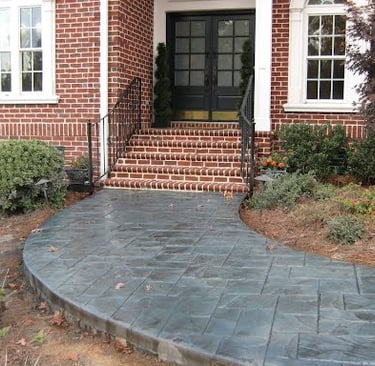 a brick house with a black door and a black door