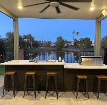 a kitchen with a large outdoor kitchen and a barbeque
