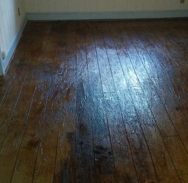 a room with a wooden floor and a window