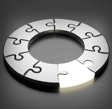 A circular metallic puzzle with one glowing piece representing a complete business solution.