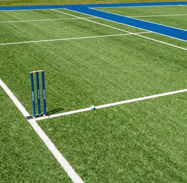 A vibrant football match underway at Vasai East turf under clear blue skies.