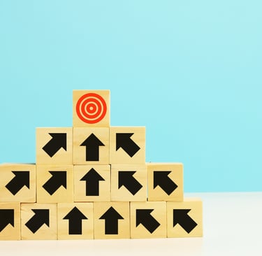 a wooden block with arrows pointing up to a target