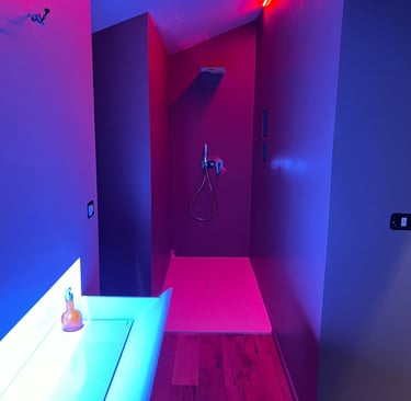 a bathroom with a pink and blue light