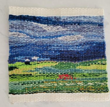 Hand-woven abstract tapestry of field and sky.