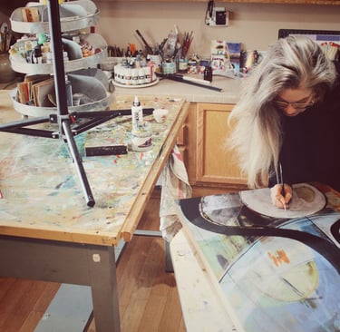 Artist Robin Arthur painting an abstract in her Paonia, Colorado studio