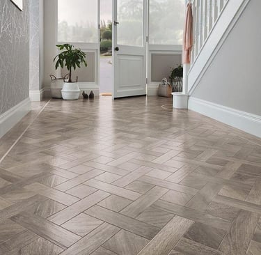 Modern basket weave LVT flooring in a bright home entryway 