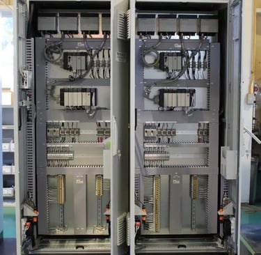 Industrial electrical control panel with organized PLC modules and wiring for automated systems.