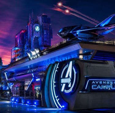 Avengers Campus at night featuring the Quinjet and illuminated logo at Disney California Adventure Park.