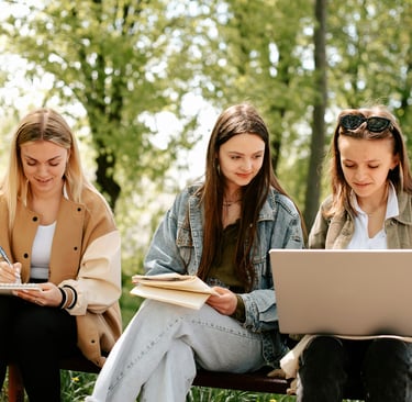 A Level Maths Online Tutoring students learn A Level Maths in Nature sitting on a bench