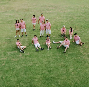 Extended family group portrait on the lawn at Alila Seminyak Bali, candid luxury family photography session.